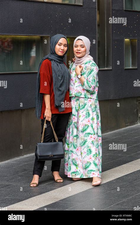 Young Malaysian Women Posing for a Photo, Traditional Dress vs. Casual ...