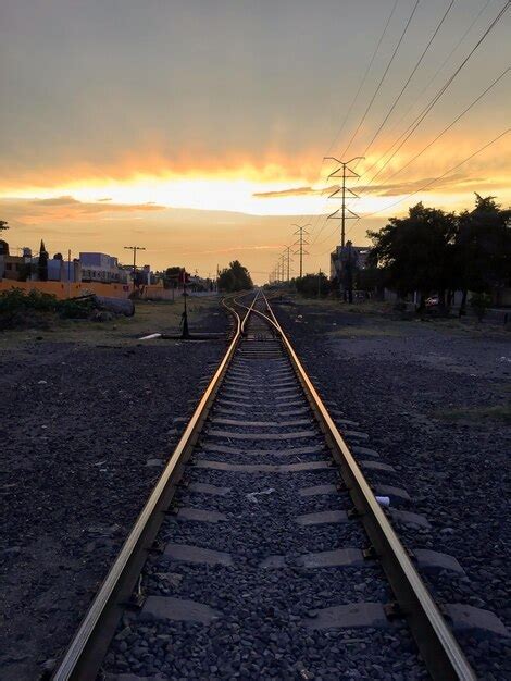 Premium Photo | Railroad tracks in the setting sun train tracks at sunset