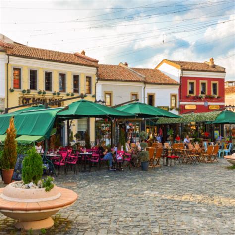 Old Bazaar of Korca city with people hanging out at cafes during summer ...