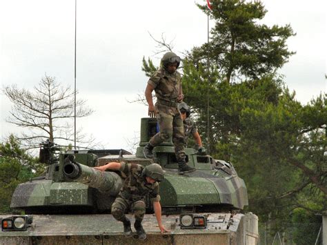 French tank crew jumping off from their tank AMX Leclerc