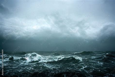 sea wave during storm in the ocean with big clouds and rain. Stock Photo | Adobe Stock