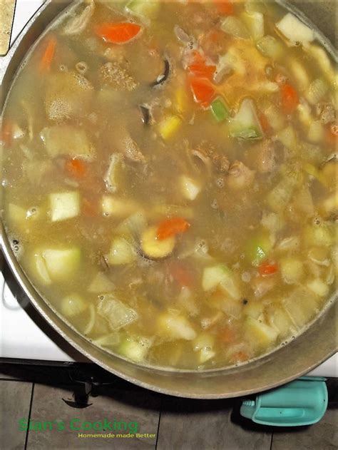 a pot filled with soup sitting on top of a stove