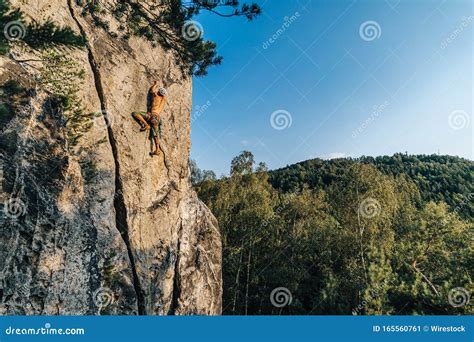 Mountain Climber Climbing the Cliff Using His Climbing Equipment ...