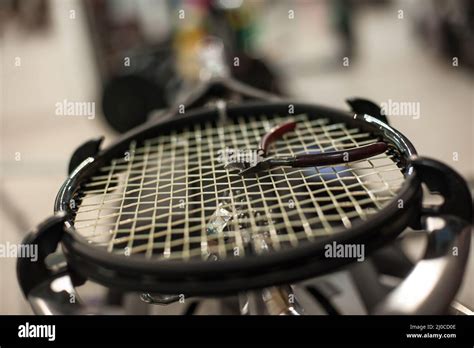 Racket stringing. Detail of tennis racket in the stringing machine Stock Photo - Alamy