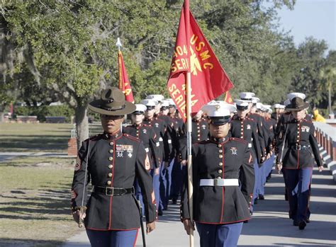 First company graduates in new dress blue uniform for female Marines