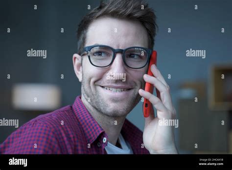 Close up photo of young handsome cheerful german man in glasses making phone call Stock Photo ...