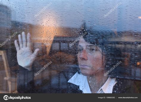 Woman Looking Out Window Rainy Day Stock Photo by ©MariaiC 199665382