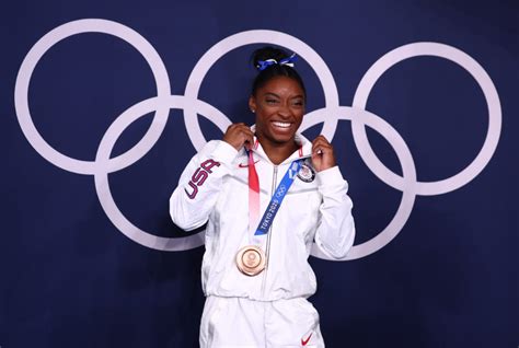 Biles returns to Olympic competition, wins bronze on beam | PBS NewsHour