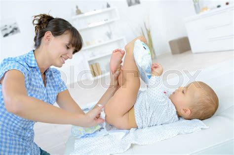 Changing the baby's diapers | Stock image | Colourbox