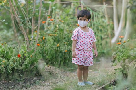 Child Wearing a Protective Face Mask on a City Street with Air ...