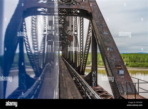 Alaska Railroad train crossing Mears Memorial railroad bridge over Tanana River at Nenana ...