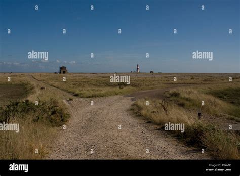 Orford ness the bomb ballistics building left and lighthouse right Stock Photo - Alamy