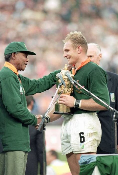 Francois Pienaar receives the rugby World Cup from Nelson Mandela ...