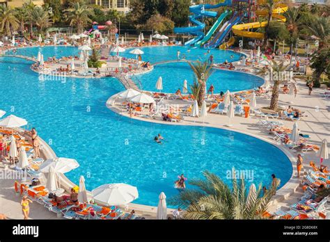 Antalya, Turkey-October 18, 2013: People swimming in the swimming pool, ,sunbathing and doing ...