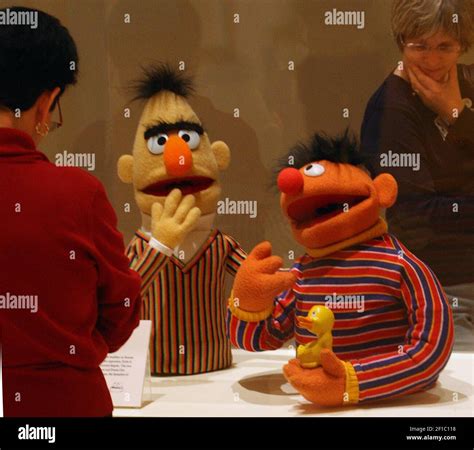 Muppets Bert, left, and Ernie, holding his rubber duckie, seem to have a conversation as they ...