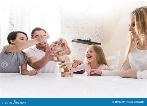 Family playing Jenga stock image. Image of lifestyle - 86023211