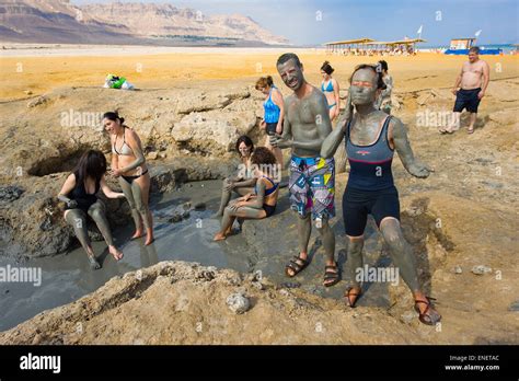 DEAD SEA, ISRAEL - OCT 13, 2014: People rub with mud on the beach of the dead sea in Israel ...