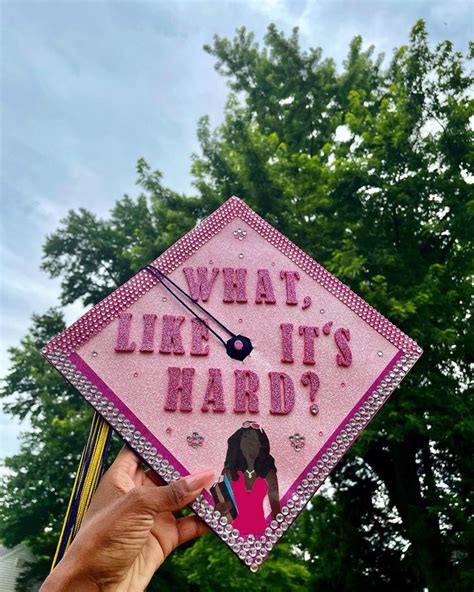 a pink graduation cap that says what like it's hard?