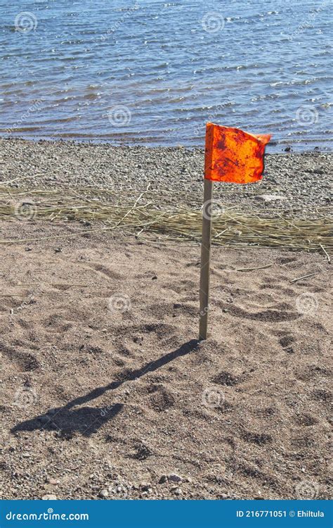 Orange flag on the beach stock image. Image of background - 216771051