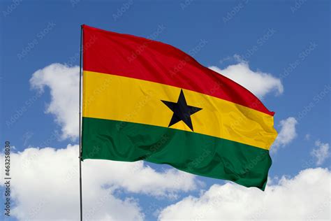 Ghana flag isolated on the blue sky background. close up waving flag of ...