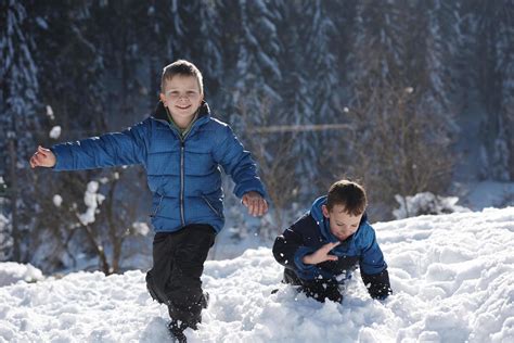 kids playing with fresh snow 11622105 Stock Photo at Vecteezy