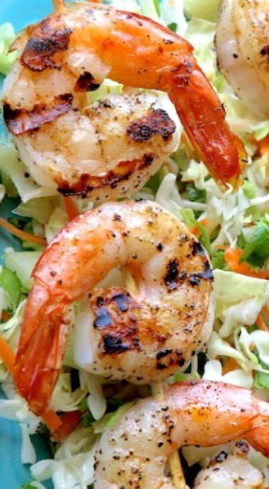 shrimp salad with lettuce and carrots on a blue plate