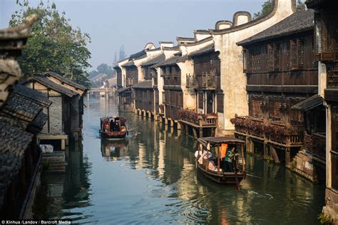 Slow boat to China: Incredible photos reveal serene river town where the waterways are streets ...