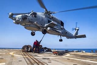 Sailors aboard USS Lassen (DDG 82) hook cargo to an MH-60R… | Flickr