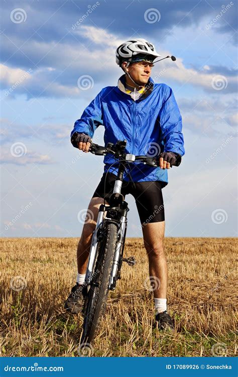 Young man on mountain bike stock photo. Image of blue - 17089926