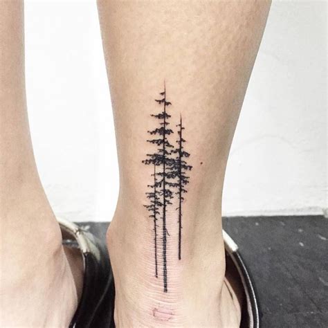 Pine tree tattoo an ankle Three black pine trees inked on the back of ...