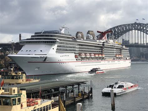 a large cruise ship in the water next to a dock with boats on it and a ...