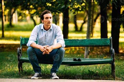 handsome adult man sitting on bench 1106094 Stock Photo at Vecteezy