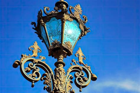 Premium Photo | Vintage metal lamp post with twisted decorations against sky