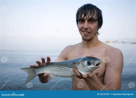 Fisherman Holds a Sea Mullet Stock Image - Image of freshly, person: 25747291