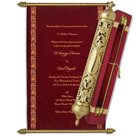 a red and gold wedding card with an ornate design on the front, inside it