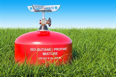 Premium Photo | Red primus stove on the green grass against blue sky 3D rendering