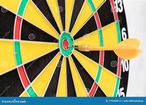 A Dart Board with an Arrow in Bullseye Close Up, Goals and Targetting ...