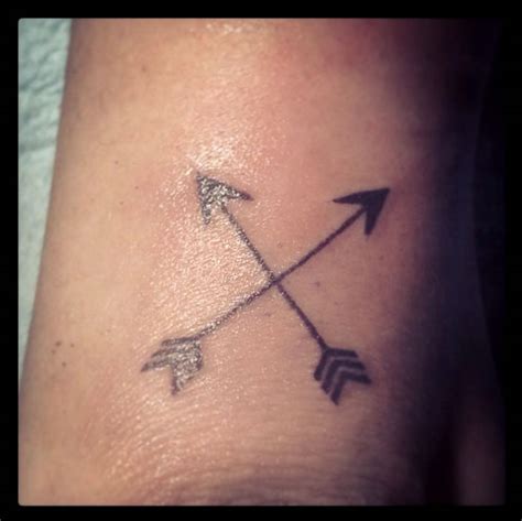 Miley Cyrus' Crossed Arrows Tattoo on Her Arm by Kat Von D- PopStarTats