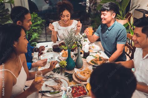 Asian group friends eating dinner at home, they are happy to talk ...