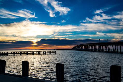 Sunrise over Assateague Island Bridge Photograph by Carol Ward - Pixels