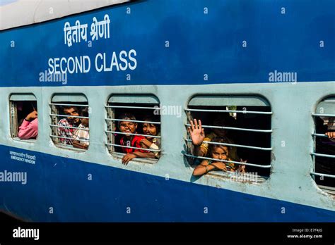 Second class Indian Railways train coach, passengers looking out of the ...