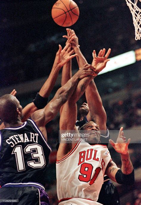 Chicago Bulls forward Dennis Rodman fights for a rebound with ...