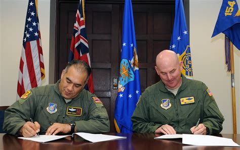 15th Wing and 154th Wing Commanders sign the MOU between the two Wings