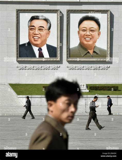 Portraits of North Korean state founder Kim Il Sung (L) and his son Kim ...