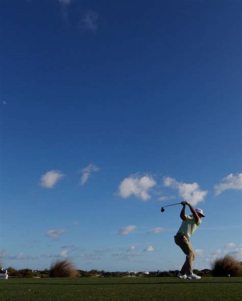 Download Xander Schauffele Golf Swing Wide Shot Wallpaper | Wallpapers.com