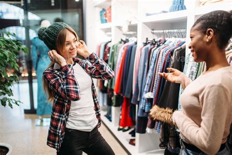 Two females buying clothes in shop, shopping Stock Photo by NomadSoul1