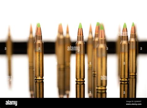 A group of 5.56 calibar, green tip bullets on white background Stock Photo - Alamy