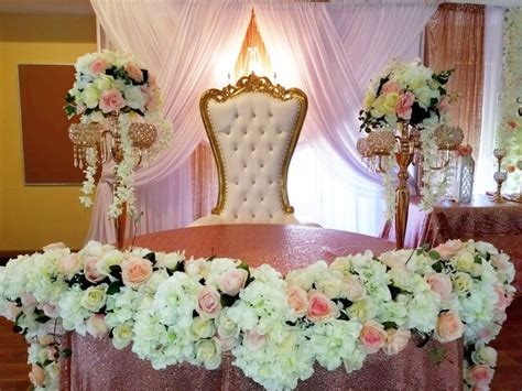 an elaborately decorated chair and table with flowers on it