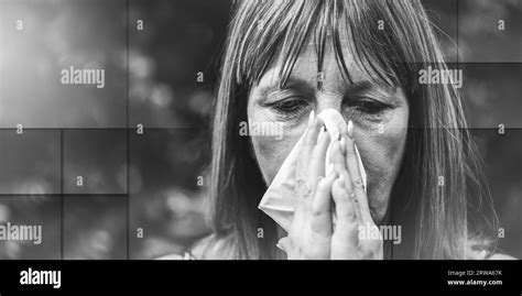 Mature woman blowing nose Black and White Stock Photos & Images - Alamy