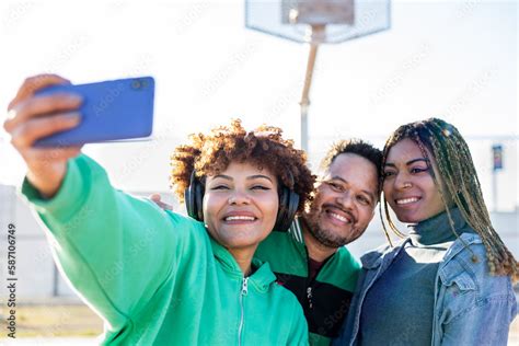 A group of happy and diverse multi-ethnic friends gather together on a ...